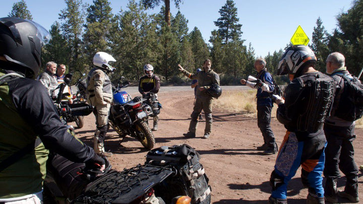 Customers of RIDE adventures listing to instructor for the RIDE off-road training course